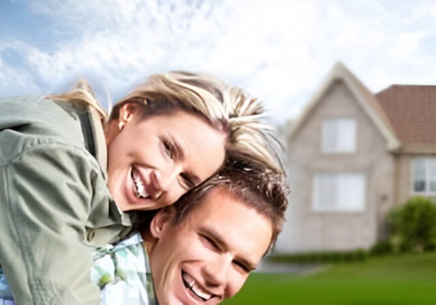 Smiling couple in front of a house.